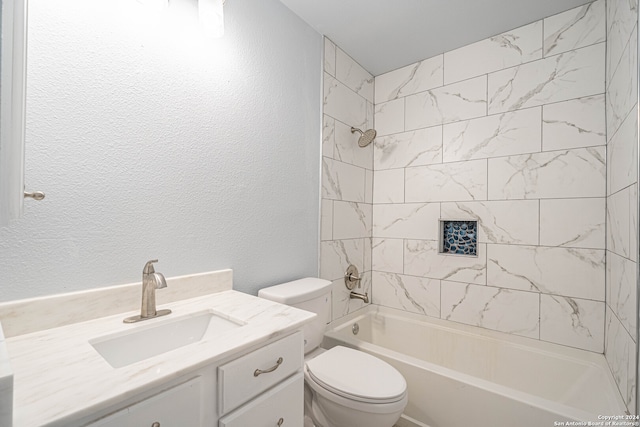 full bathroom with vanity, toilet, and tiled shower / bath