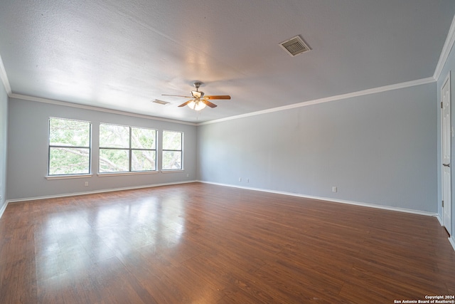 empty room featuring a textured ceiling, ceiling fan, dark hardwood / wood-style floors, and ornamental molding