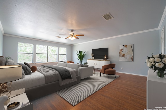 bedroom with dark hardwood / wood-style flooring, ceiling fan, and ornamental molding