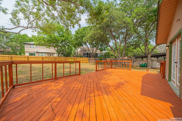 wooden terrace featuring a yard