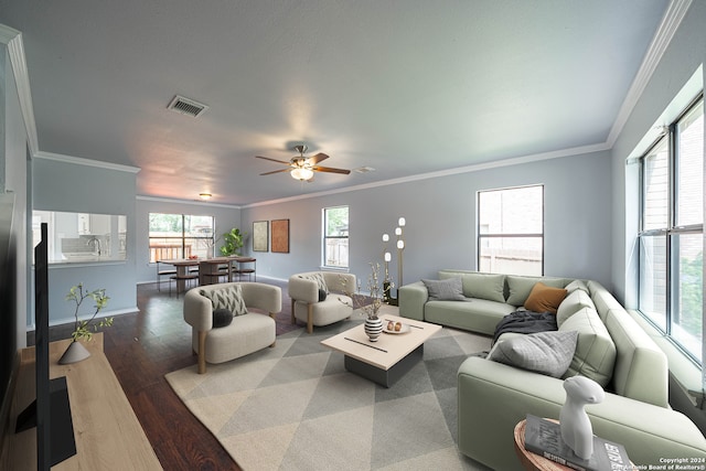 living room with dark hardwood / wood-style flooring, ceiling fan, and ornamental molding