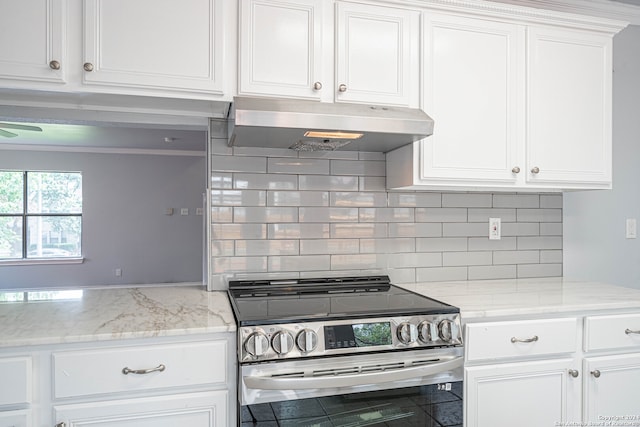 kitchen featuring white cabinets, stainless steel electric range, light stone counters, and backsplash