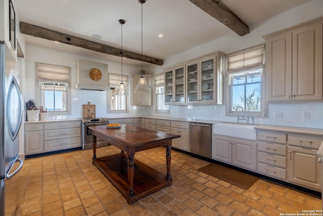 kitchen featuring sink, beamed ceiling, backsplash, pendant lighting, and appliances with stainless steel finishes