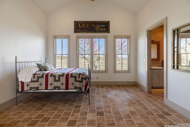 bedroom featuring connected bathroom and vaulted ceiling