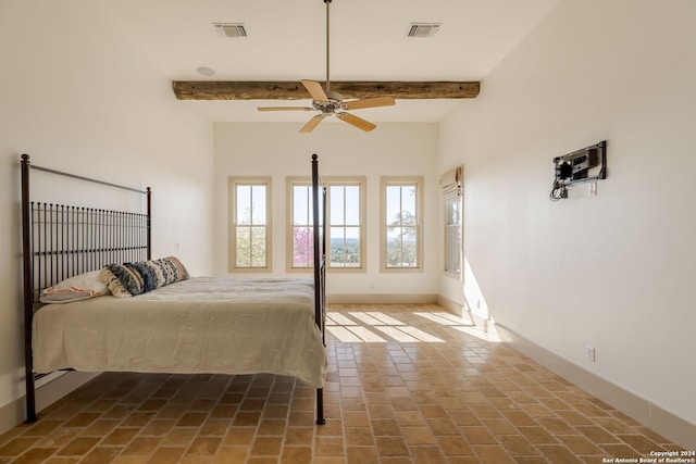 bedroom with beamed ceiling and ceiling fan