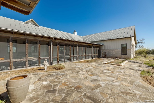 view of patio with a sunroom