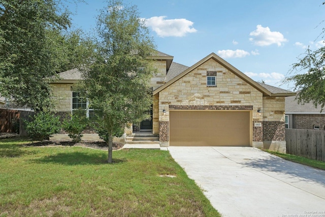 view of front of property with a front yard and a garage