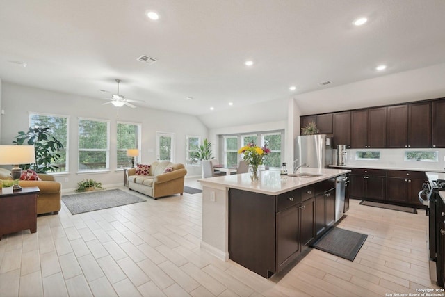 kitchen with light countertops, open floor plan, visible vents, and appliances with stainless steel finishes