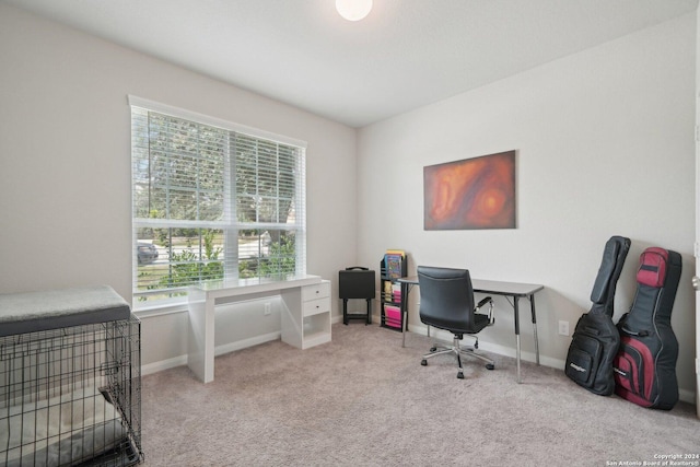 carpeted home office featuring baseboards