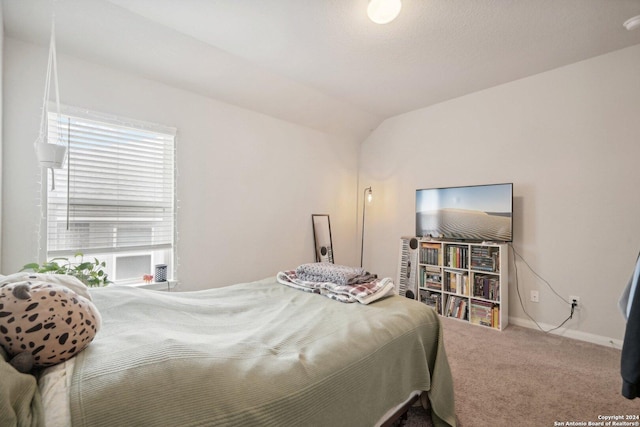 bedroom featuring carpet flooring, baseboards, and vaulted ceiling