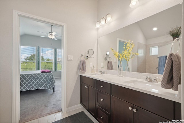 ensuite bathroom with plenty of natural light, ensuite bathroom, lofted ceiling, and a sink