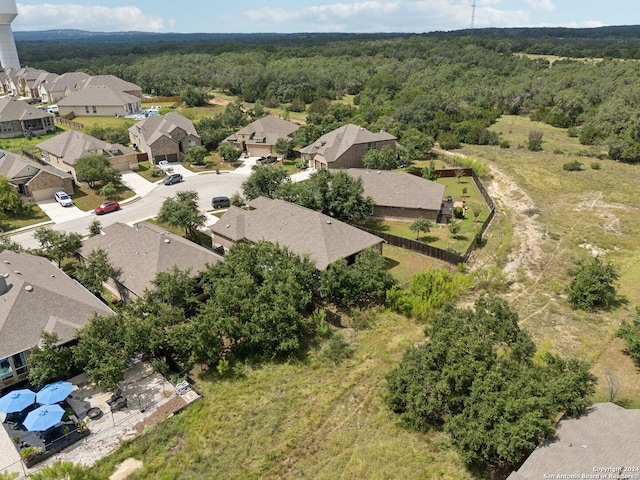 drone / aerial view with a forest view and a residential view