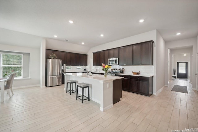 kitchen with dark brown cabinetry, appliances with stainless steel finishes, and light countertops