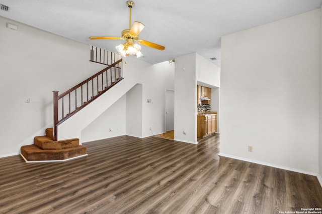 unfurnished living room with dark hardwood / wood-style floors and ceiling fan