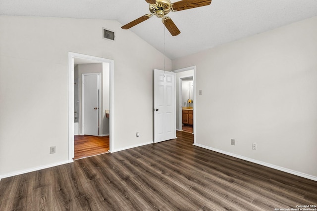 unfurnished bedroom with a textured ceiling, lofted ceiling, ceiling fan, and dark hardwood / wood-style floors