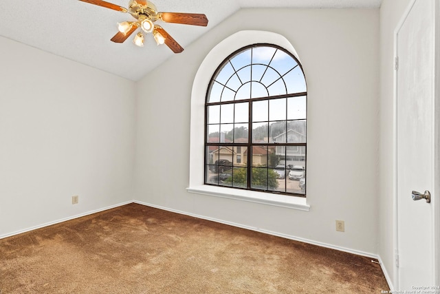 unfurnished room with a textured ceiling, ceiling fan, carpet floors, and vaulted ceiling