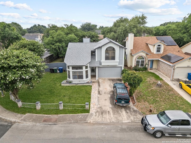 view of front of home featuring a front yard and a garage