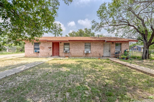 ranch-style home featuring a front lawn and cooling unit