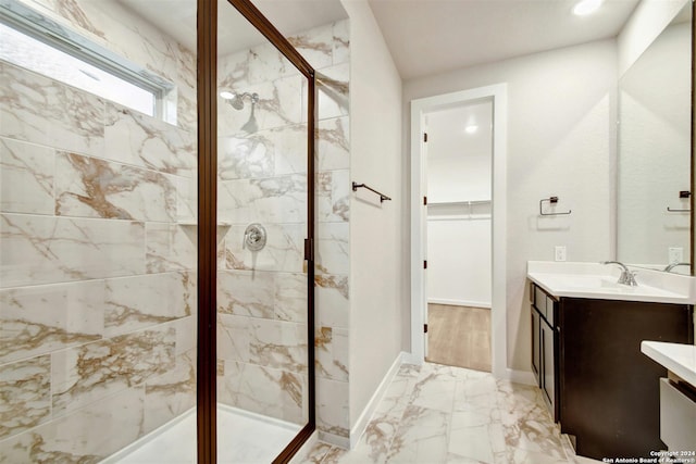 bathroom with vanity and a shower with door