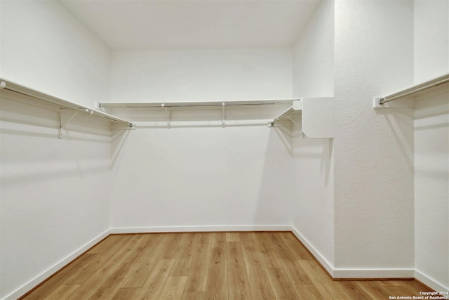 spacious closet with light hardwood / wood-style floors