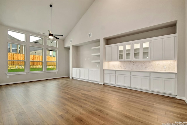 unfurnished living room featuring ceiling fan, high vaulted ceiling, and light hardwood / wood-style flooring