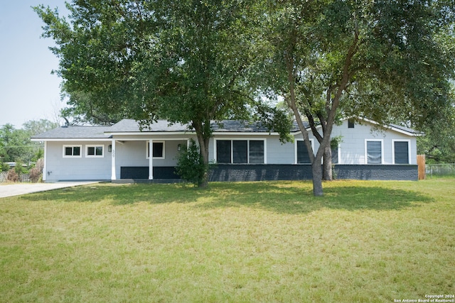 single story home featuring a garage and a front lawn