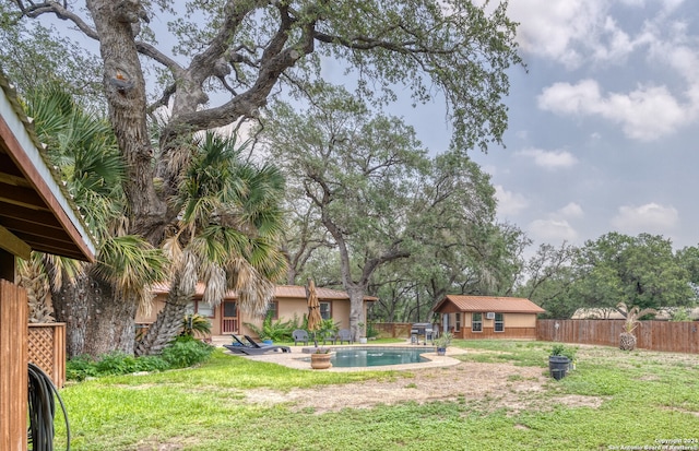 view of yard featuring an outbuilding and a fenced in pool