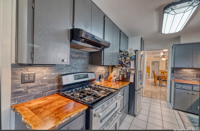 kitchen with a textured ceiling, backsplash, stainless steel appliances, and range hood