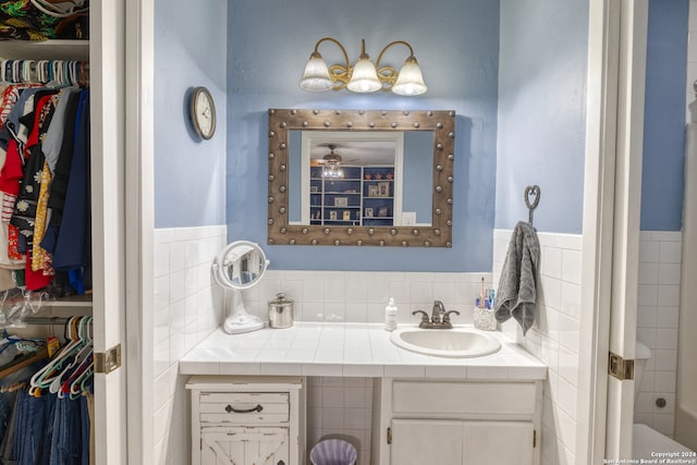 bathroom with vanity and tile walls