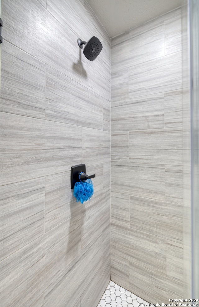 bathroom with a tile shower