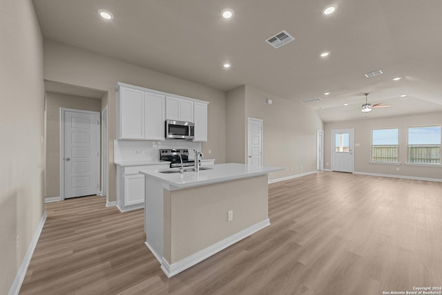 kitchen featuring ceiling fan, appliances with stainless steel finishes, sink, white cabinetry, and a kitchen island with sink