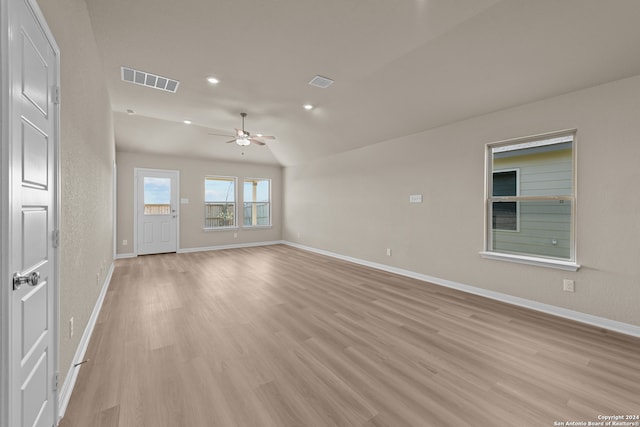 unfurnished living room featuring light hardwood / wood-style floors, ceiling fan, and lofted ceiling