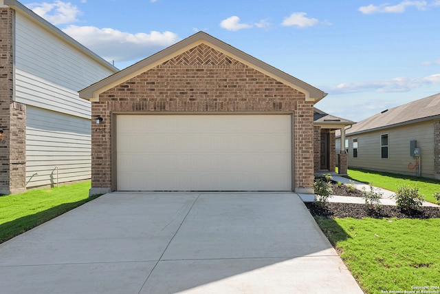 view of front facade with a front yard and a garage