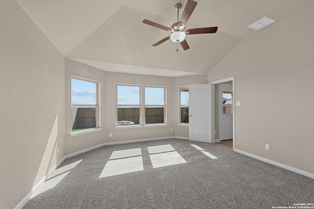 carpeted spare room featuring ceiling fan and lofted ceiling