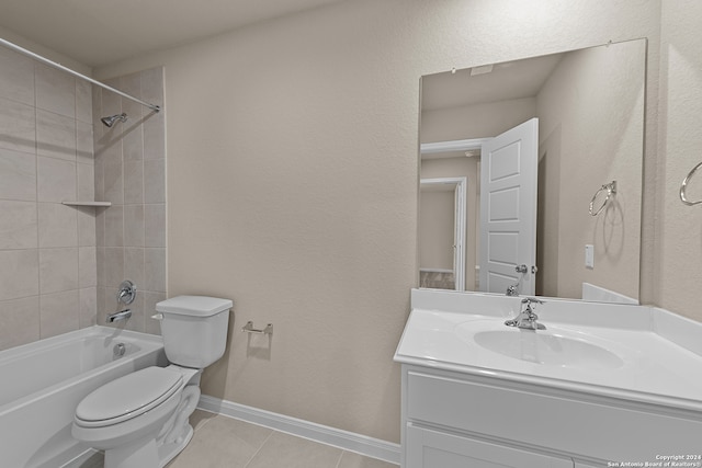 full bathroom with tile patterned flooring, vanity, tiled shower / bath combo, and toilet