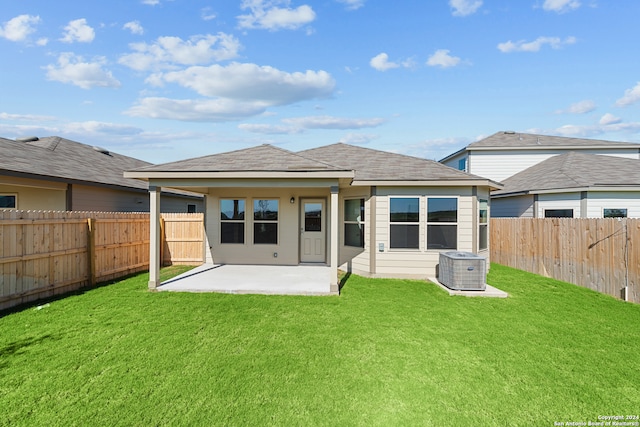 back of house featuring a lawn and a patio area