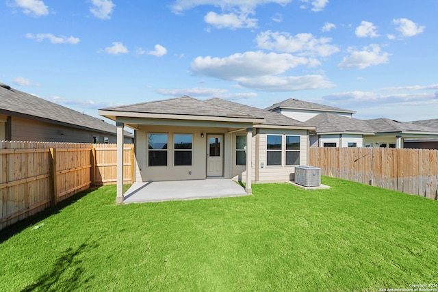 back of property featuring a patio area, a yard, and central AC unit