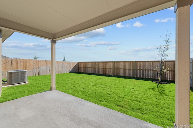 view of yard with cooling unit and a patio