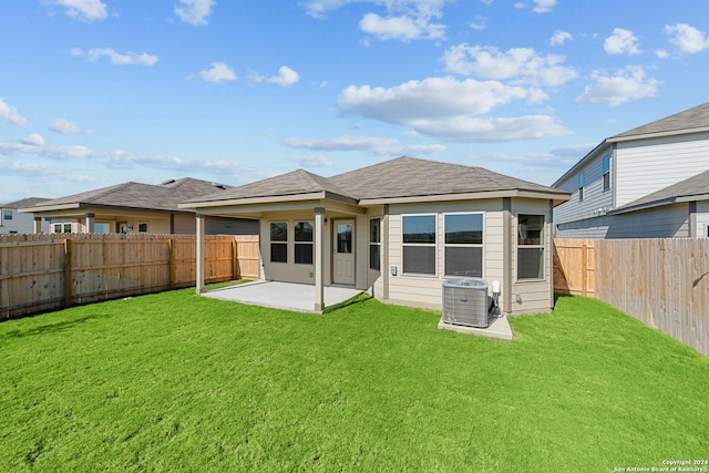 back of house with a patio, a lawn, and central AC