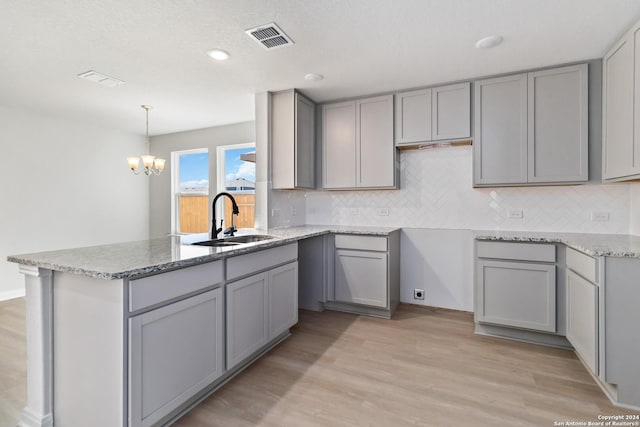 kitchen with gray cabinetry and sink