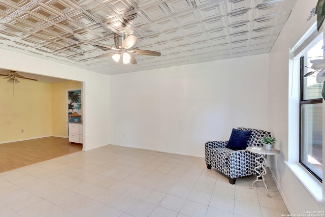 sitting room with ceiling fan and light wood-type flooring