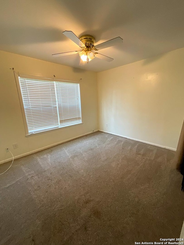 carpeted empty room with ceiling fan