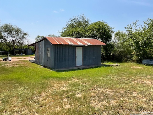 view of outbuilding featuring a yard