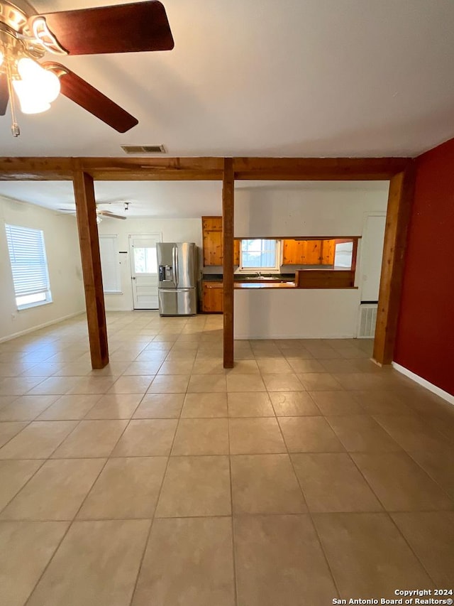 unfurnished living room with ceiling fan and light tile patterned flooring