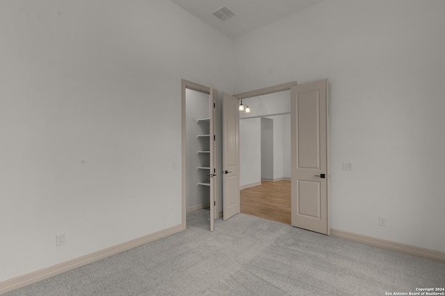 unfurnished bedroom featuring light colored carpet