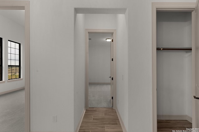 hallway with light colored carpet