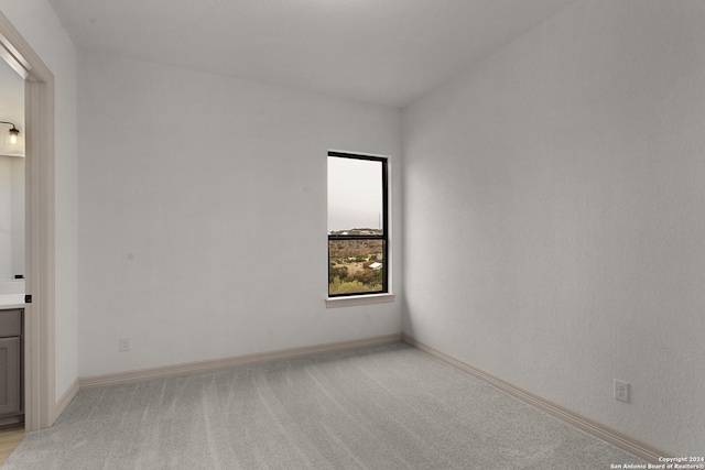 unfurnished room with light carpet