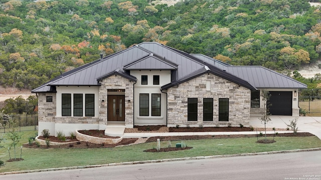 modern farmhouse style home featuring a garage and a front yard