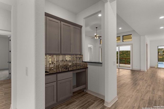 kitchen with hardwood / wood-style floors, decorative backsplash, and ceiling fan