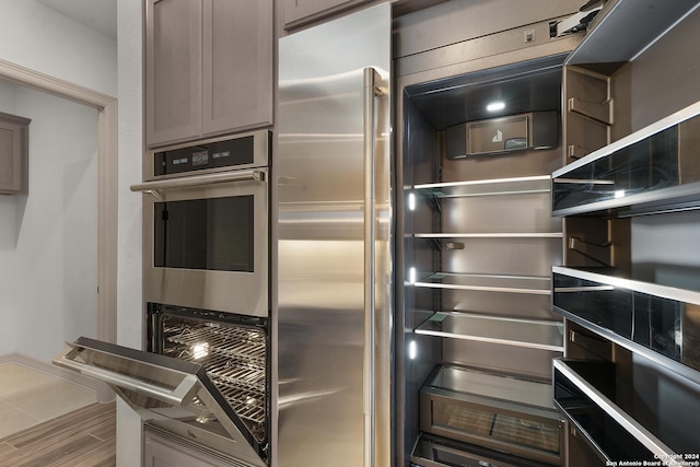 kitchen with double oven and fridge